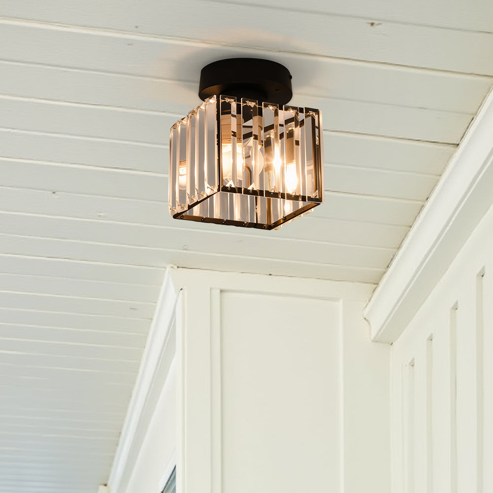 Modern black crystal flush mount ceiling light, sleek brass fixture, crystal shade, ideal for rooms with low ceilings.