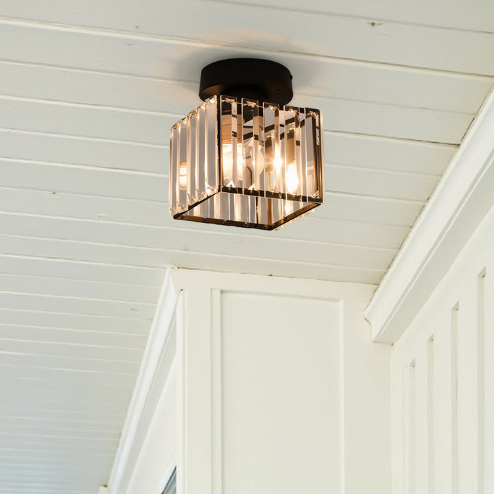 Modern black crystal flush mount ceiling light, sleek brass fixture, crystal shade, ideal for rooms with low ceilings.