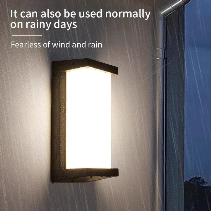 Modern black LED outdoor wall light with motion sensor, waterproof ABS, enhances security, suits balconies, porches, gardens.