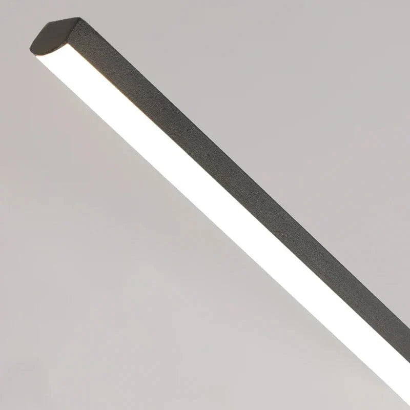 "Modern black pendant light with tubular silhouette, minimalist aluminium fixture, perfect for dining rooms and kitchens."