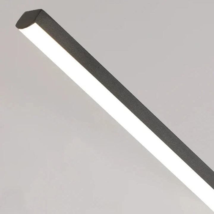 "Modern black pendant light with tubular silhouette, minimalist aluminium fixture, perfect for dining rooms and kitchens."