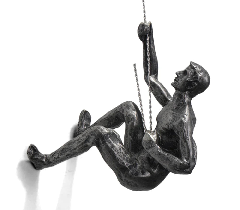 Sleek metallic climber sculpture, a modern wall art piece for office & home interior design.