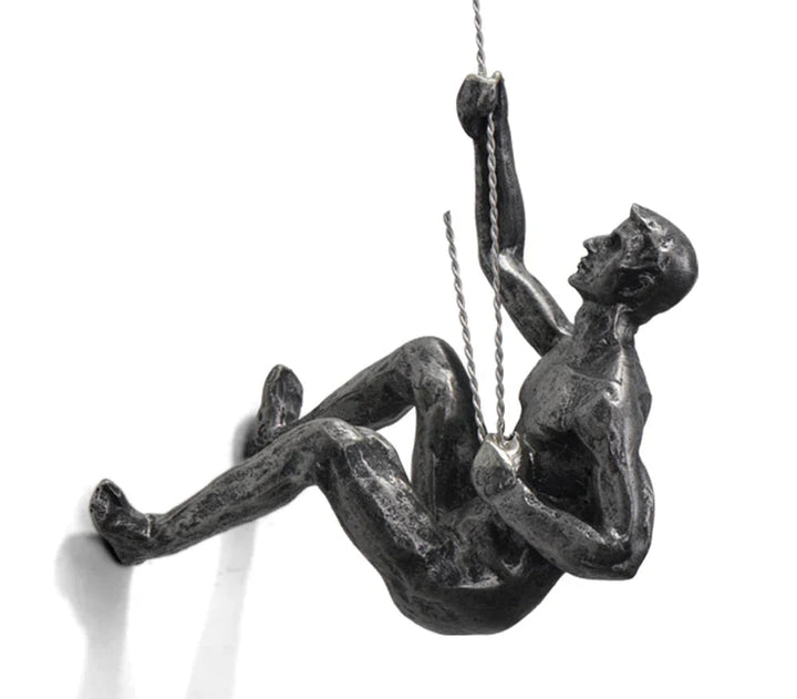 Sleek metallic climber sculpture, a modern wall art piece for office & home interior design.
