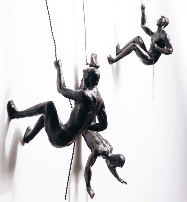 Inspirational climber wall art sculpture, adding modern artistic flair to home or office decor.