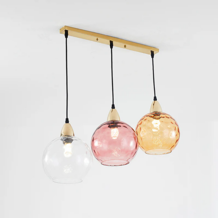 Adjustable modern cluster pendant, 3 lights illuminate living spaces with LED glow.