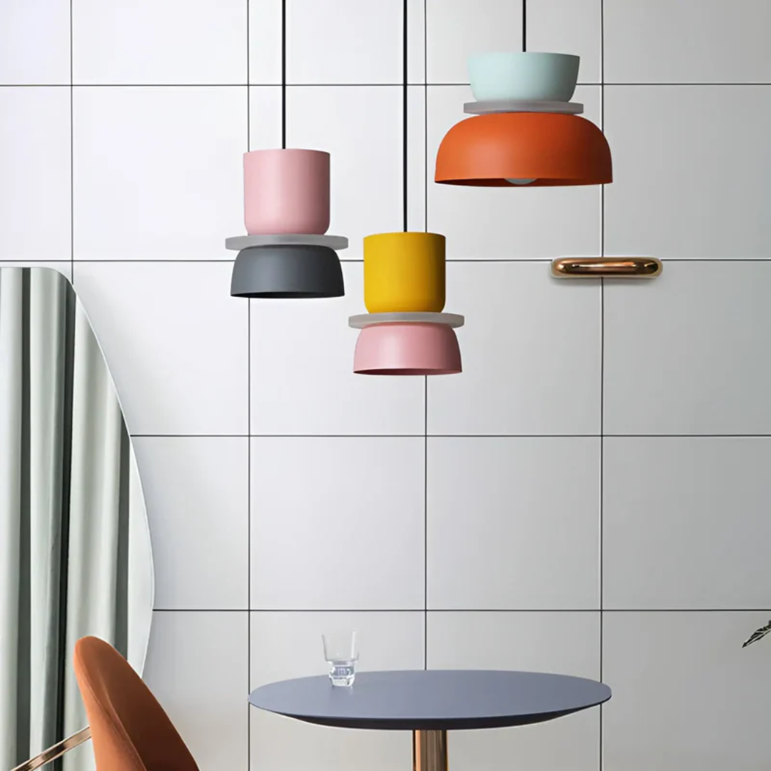 Modern colorful LED macaron pendant light suspended from ceiling, enhancing home ambiance.