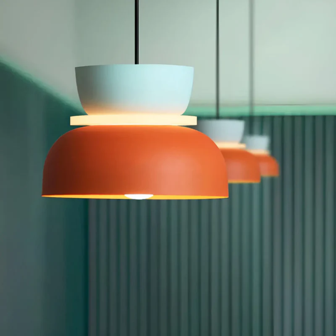 Warm, inviting glow from a modern colorful LED macaron pendant light, cozy home lighting.