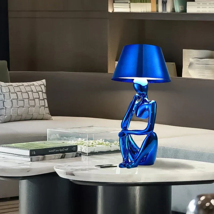 Blue modern table lamp for sophisticated ambient lighting. Designer accent lamp ideal for living room or bedroom decor.