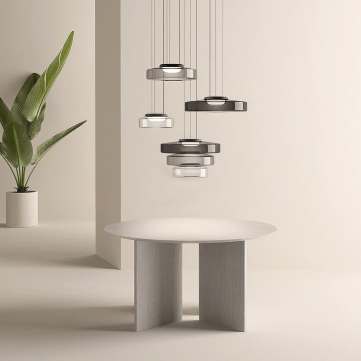"Modern glass pendant lamp in Bauhaus design, smoke grey shade, adjustable cable, warm LED glow, ideal for home interiors."
