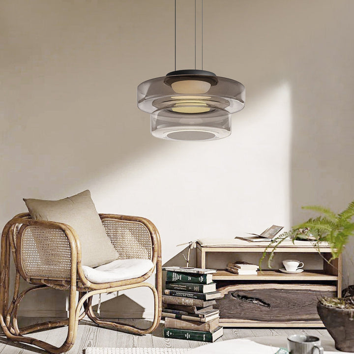 "Modern glass pendant lamp in Bauhaus design, smoke grey shade, adjustable cable, warm LED glow, ideal for home interiors."