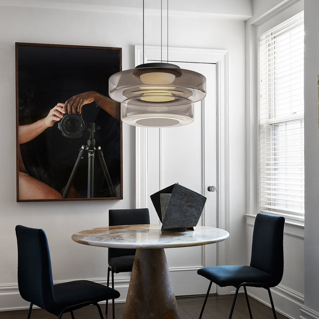 "Modern glass pendant lamp in Bauhaus design, smoke grey shade, adjustable cable, warm LED glow, ideal for home interiors."