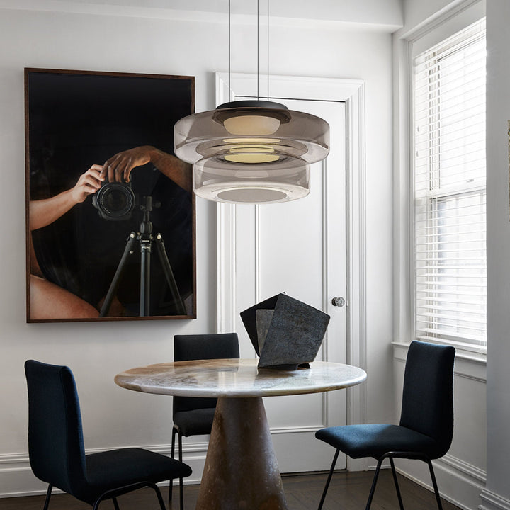 "Modern glass pendant lamp in Bauhaus design, smoke grey shade, adjustable cable, warm LED glow, ideal for home interiors."
