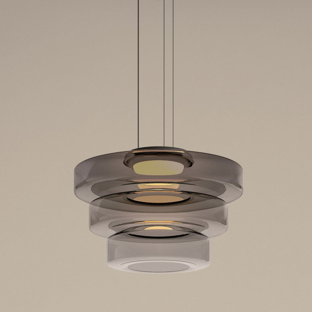 "Modern glass pendant lamp in Bauhaus design, smoke grey shade, adjustable cable, warm LED glow, ideal for home interiors."
