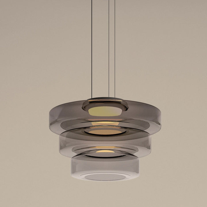 "Modern glass pendant lamp in Bauhaus design, smoke grey shade, adjustable cable, warm LED glow, ideal for home interiors."