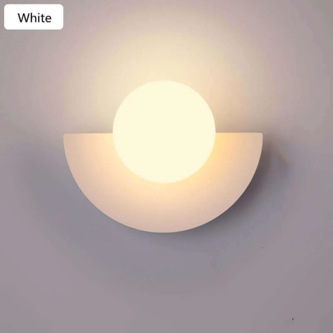 Designer metal half moon LED wall lamp, casting a soft ambient glow for modern interiors.