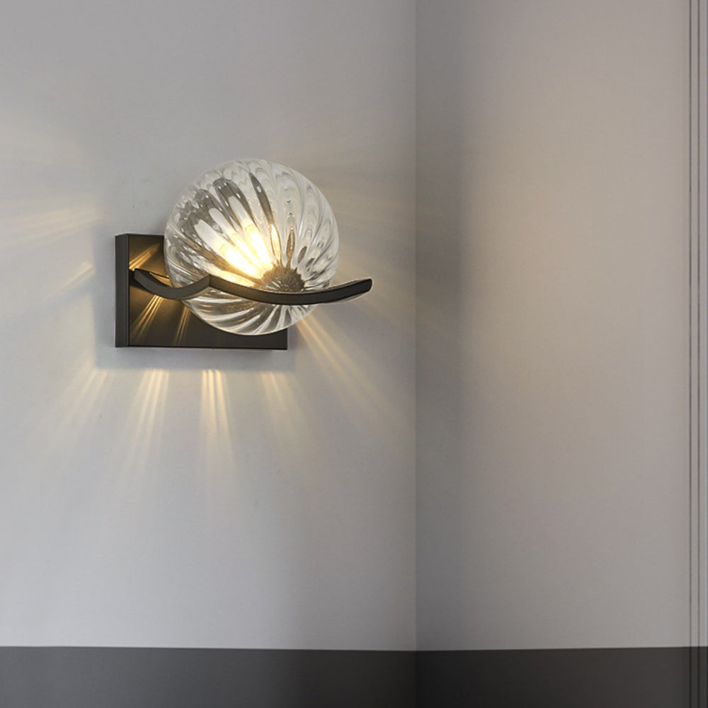 Brown glass LED wall lamp adding warm ambiance to a bedroom.