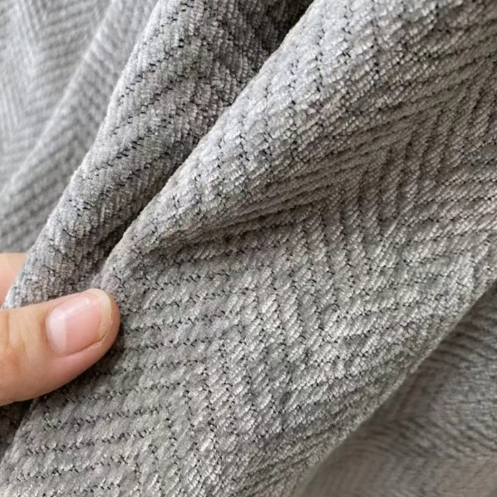 Elegant minimalist sofa throw blanket enhancing modern living room decor with its simple, chic design & comfort.