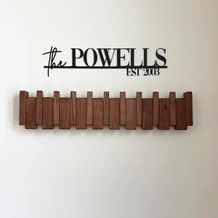 Stylish walnut wood piano key coat rack, wall-mounted. Home decor for coats, hats & bags, modern design.