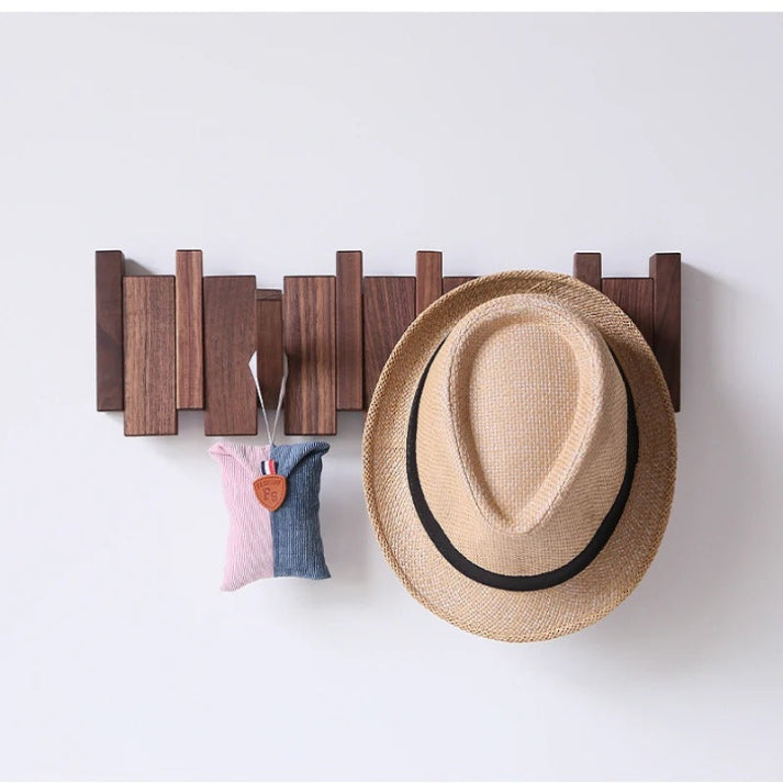 Walnut wooden piano key coat rack, 6 retractable hooks. Elegant & modern entryway organization solution.