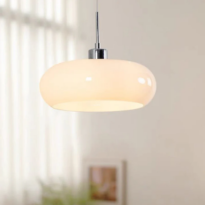 Sleek round LED pendant light, RadianceOrb, providing warm white illumination for a cozy living room ambiance.