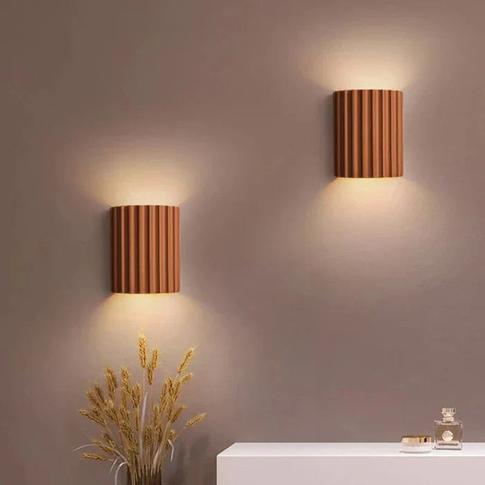 Artistic resin wall light with a unique modern wave design, ideal for living rooms.