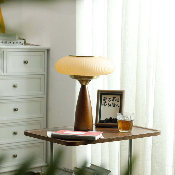 Bedside table lamp, modern wood design with a sophisticated glass shade, warm ambient light.