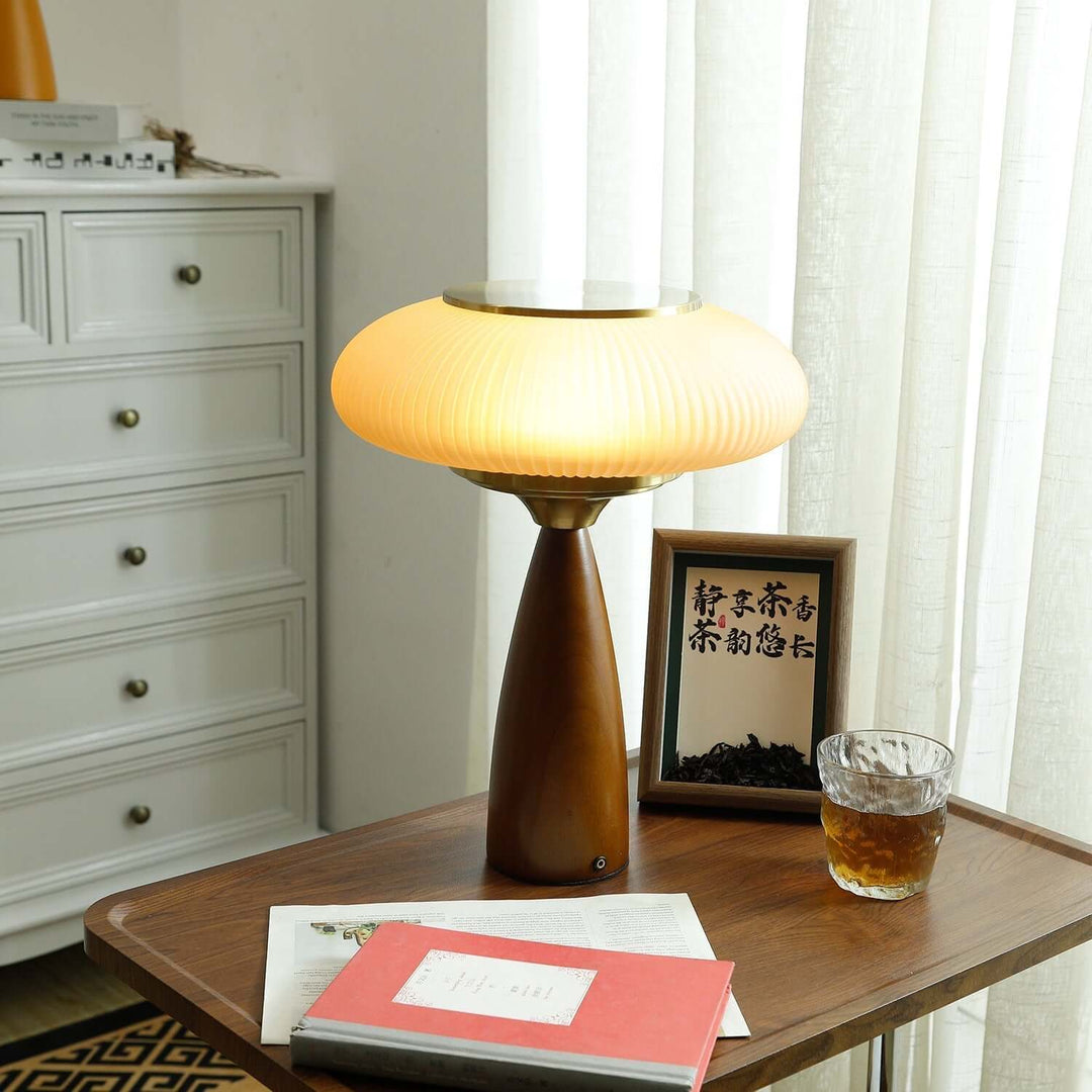 Artistic wooden base table lamp with a sculptural glass shade, ideal for stylish home decor.