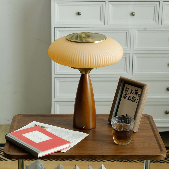 Contemporary wood table lamp featuring a clear glass shade, ideal for modern lighting.