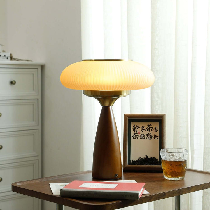 Elegant modern wooden table lamp with a beautiful glass shade, enhancing any interior design.