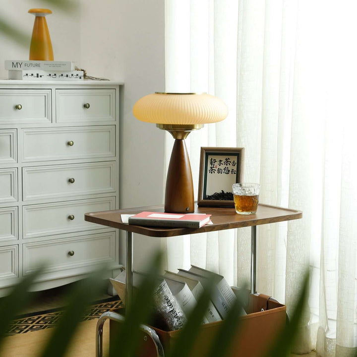 Decorative wooden table lamp with a clear glass shade, a chic addition to home decor.
