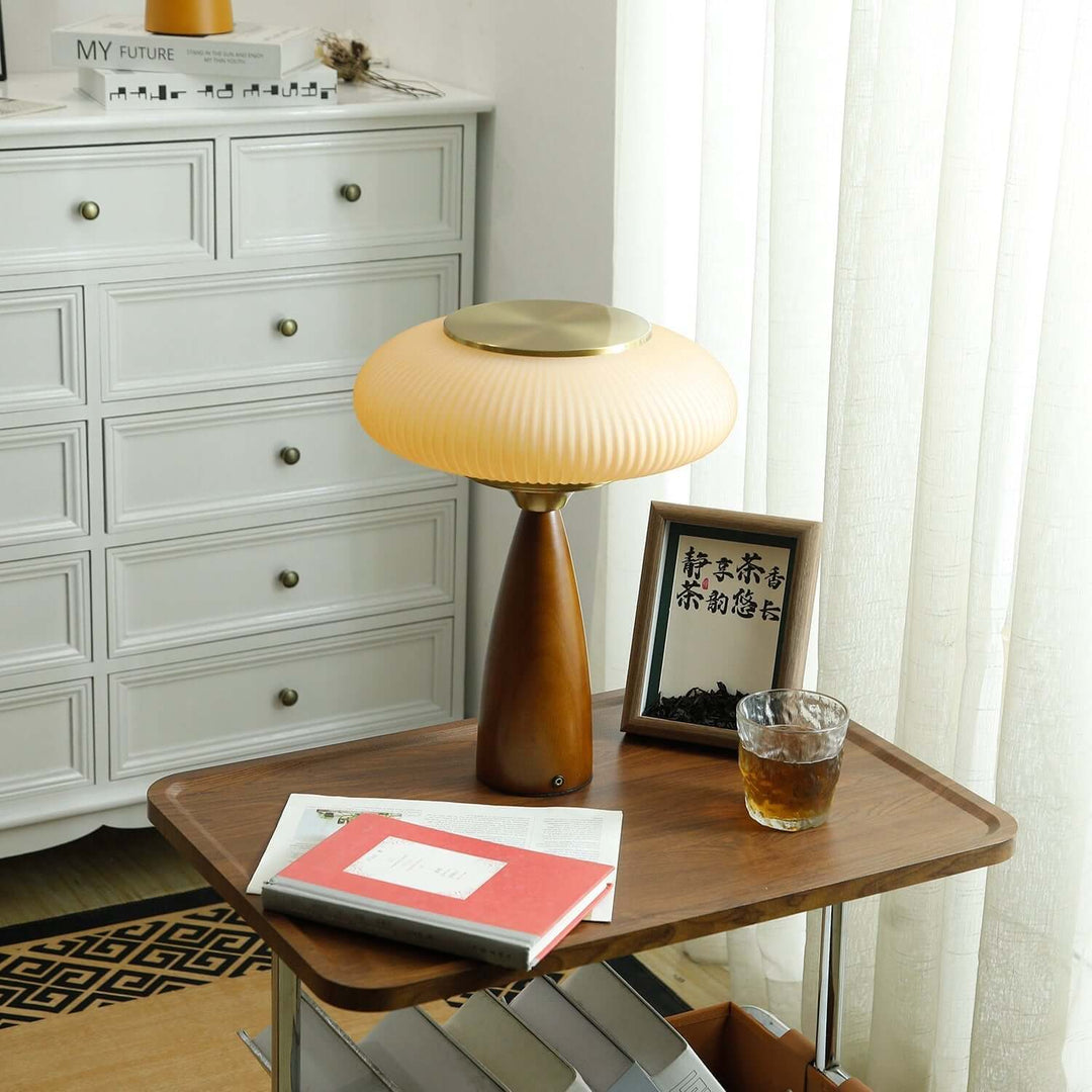 Minimalist wooden base table lamp with a stunning glass shade, great for desk lighting.