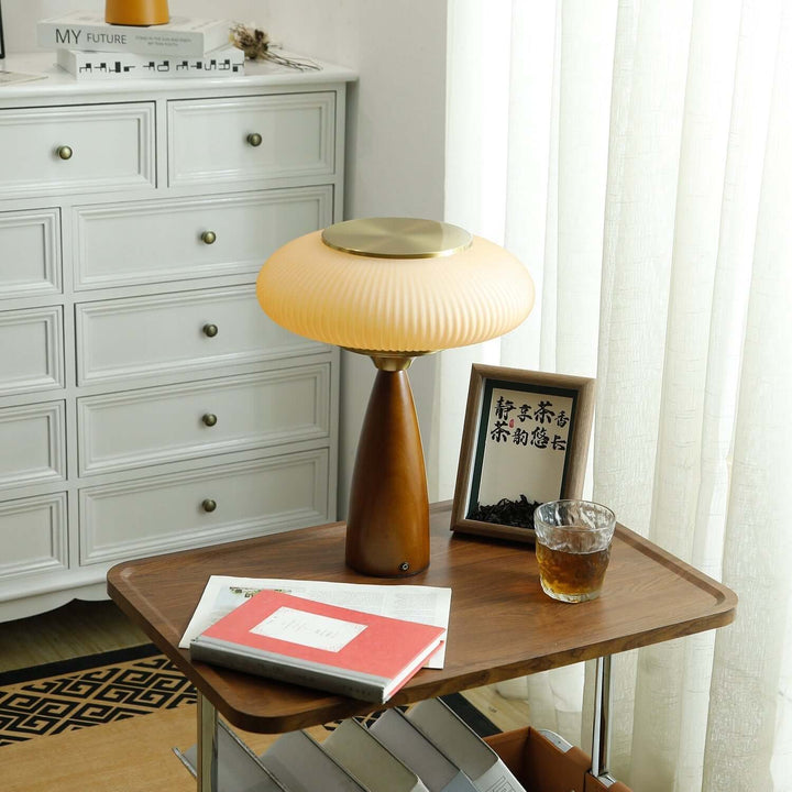 Minimalist wooden base table lamp with a stunning glass shade, great for desk lighting.