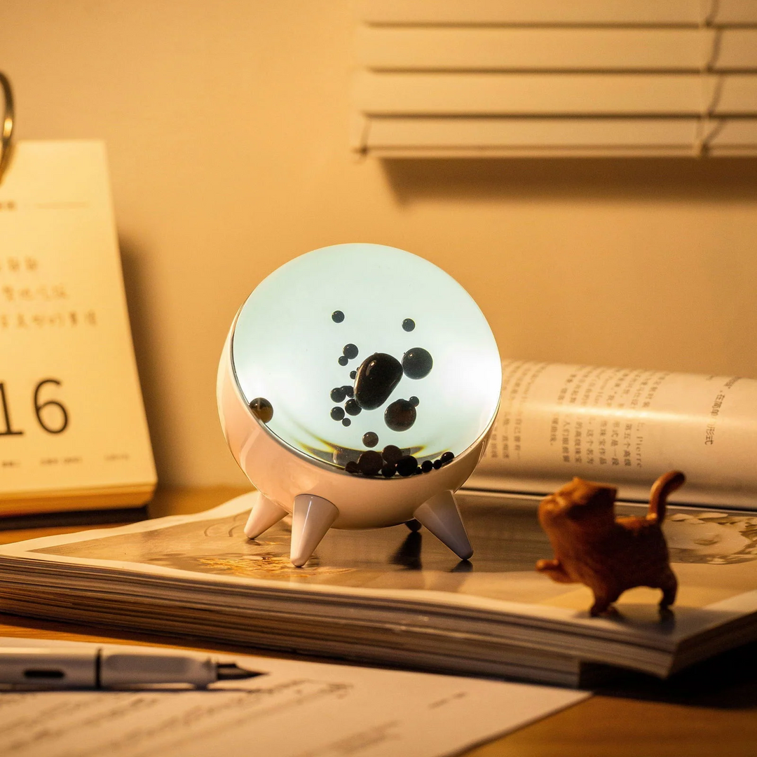 "Music-reactive ferrofluid display with black fluid art in motion, Bluetooth connectivity, and built-in lighting for tech lov
