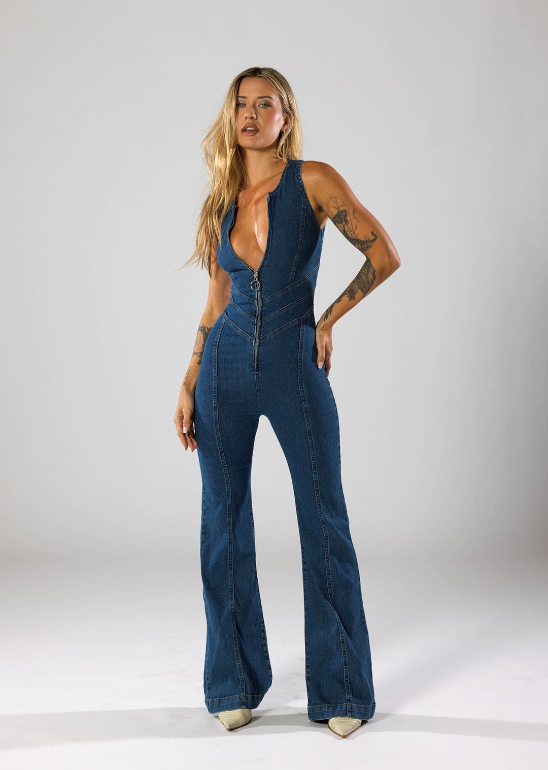 Fitted navy blue women's jumpsuit with a heart-shaped plunge neckline. Fashionable evening wear for parties.