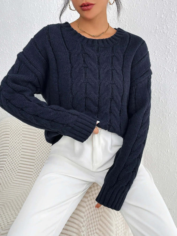 Navy blue women's twisted knit jumper. Cozy, loose fit sweater for winter fashion & casual style.