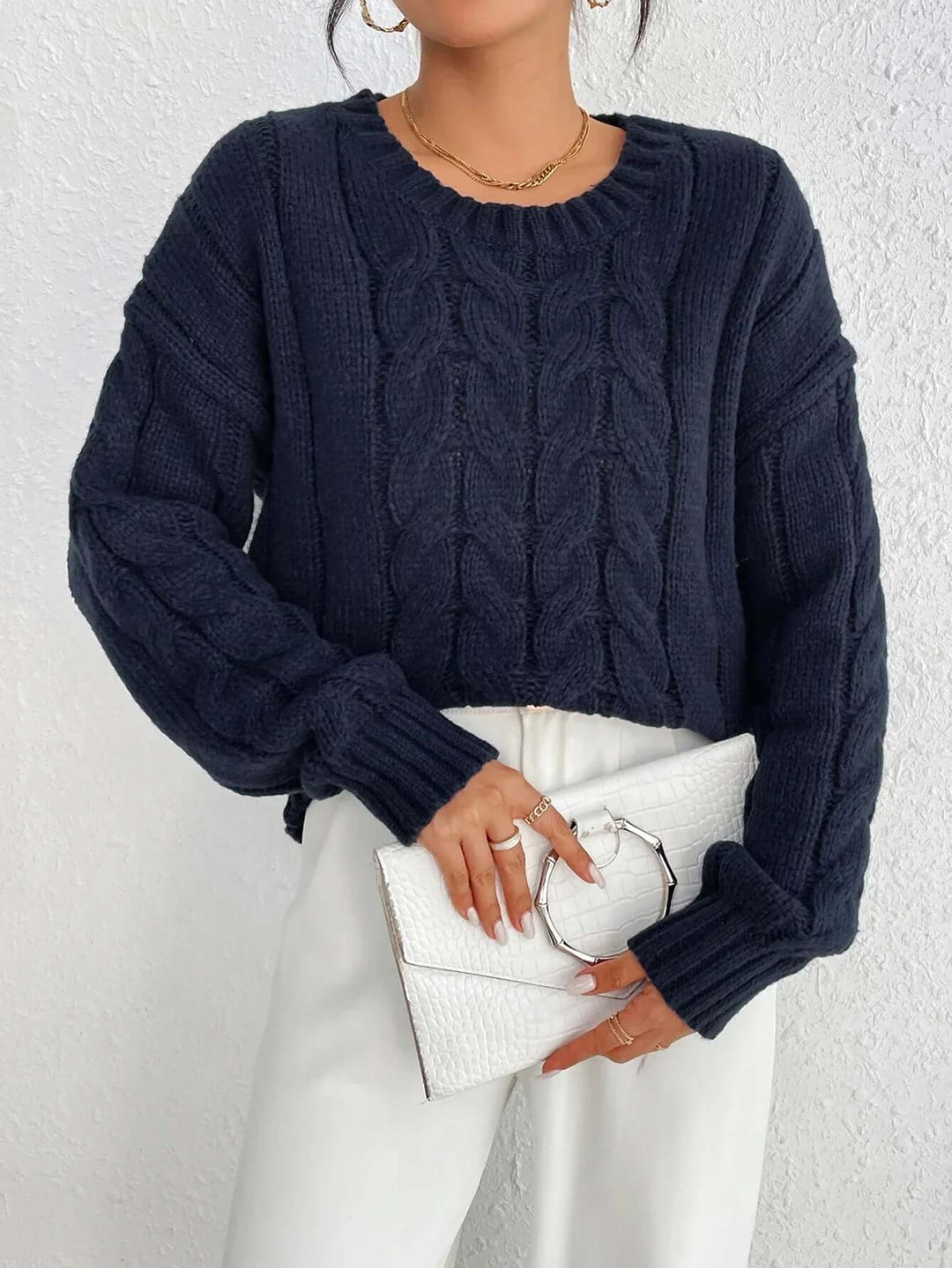 Comfortable navy blue twisted knit women's jumper. Elegant, cozy knitwear with a loose fit for effortless style.