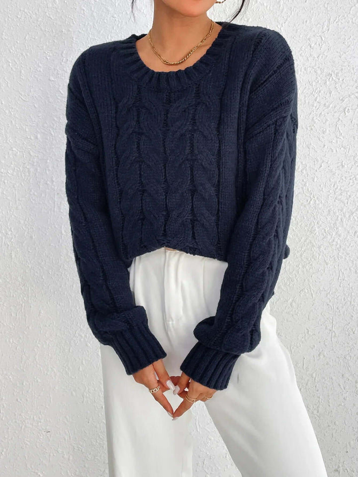 Detailed twisted knit women's jumper in navy blue. Loose fit, cozy sweater perfect for elegant winter fashion.
