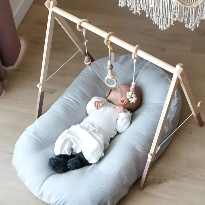 Orthopedic baby cushion in pink, supportive ergonomic design for healthy sleep, prevents flat head syndrome, soft material.