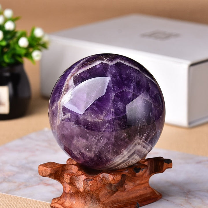 Polished Amethyst crystal sphere, a natural gemstone promoting healing & calming as spiritual home decor.