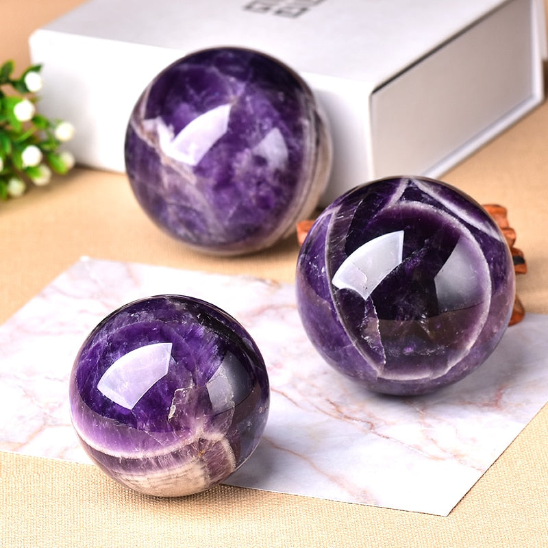 Smooth Amethyst gemstone sphere for home decor, offering spiritual calming & a natural accent for any room.