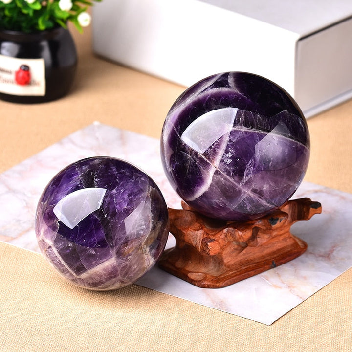 Hand-polished Amethyst healing crystal sphere, a powerful natural gemstone perfect for spiritual home decor.