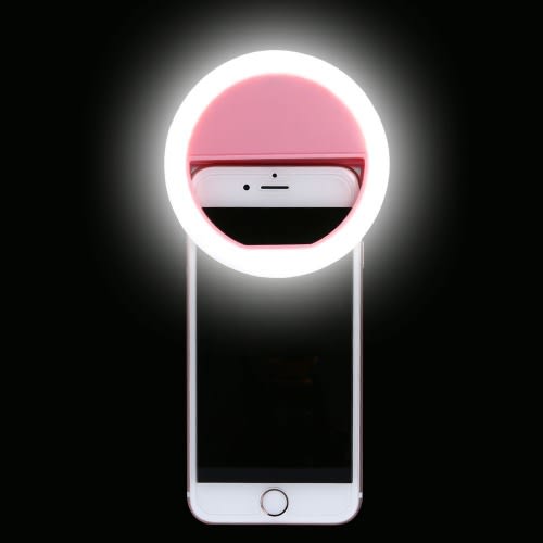Adjustable LED ring light clipped onto a phone, ideal for video calls and content creation.