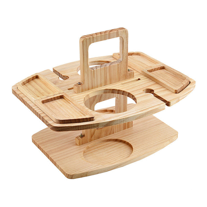 Compact foldable wood wine table with snack & drink holders, ideal for a romantic outdoor picnic.
