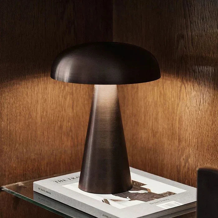 Stylish ShroomLite portable LED table lamp, rechargeable, enhancing home decor with warm ambient light.