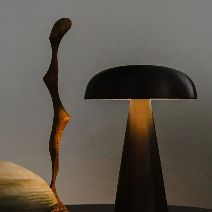 ShroomLite portable LED table lamp, illuminating a modern living space with soft ambient mood lighting.