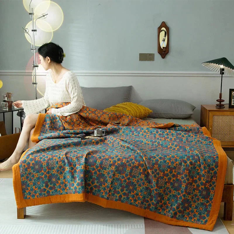 Six-layer cotton quilt with vibrant orange & blue pattern. Soft, cozy bedding for bedroom decor.