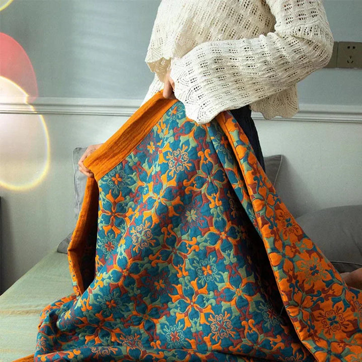 Soft 6-layer cotton quilt in an eye-catching orange and blue pattern. Ideal cozy blanket for home textile.