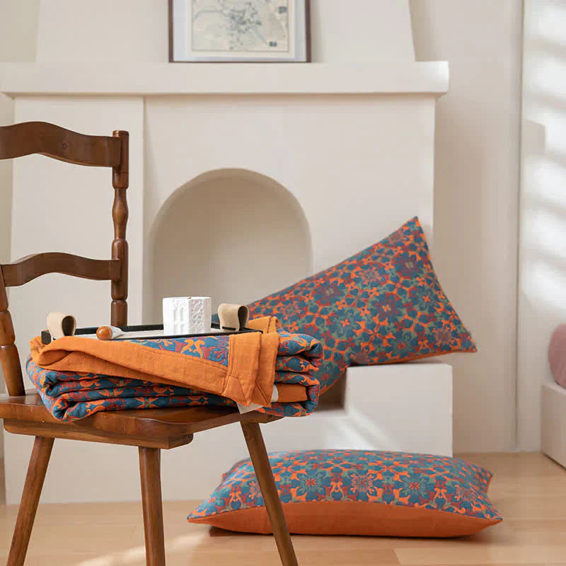 Luxurious orange & blue patterned six-layer cotton quilt. A soft, organic bedding choice for modern decor.
