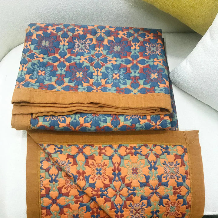 Cozy six-layer cotton quilt by TerraLoom, featuring an elegant orange & blue pattern for inviting bedding.