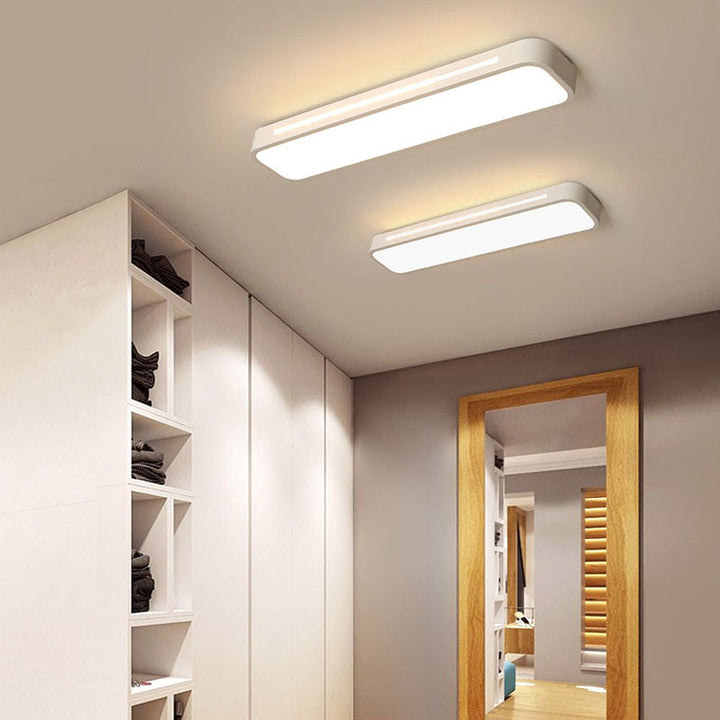 "Sleek minimalist linear LED ceiling light with iron and acrylic design, perfect for modern homes, available in three sizes."